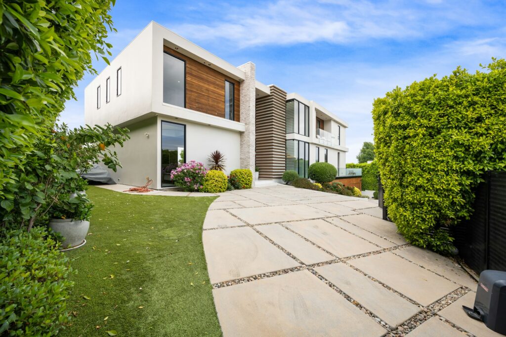 Driveway of a contemporary house with a garden area